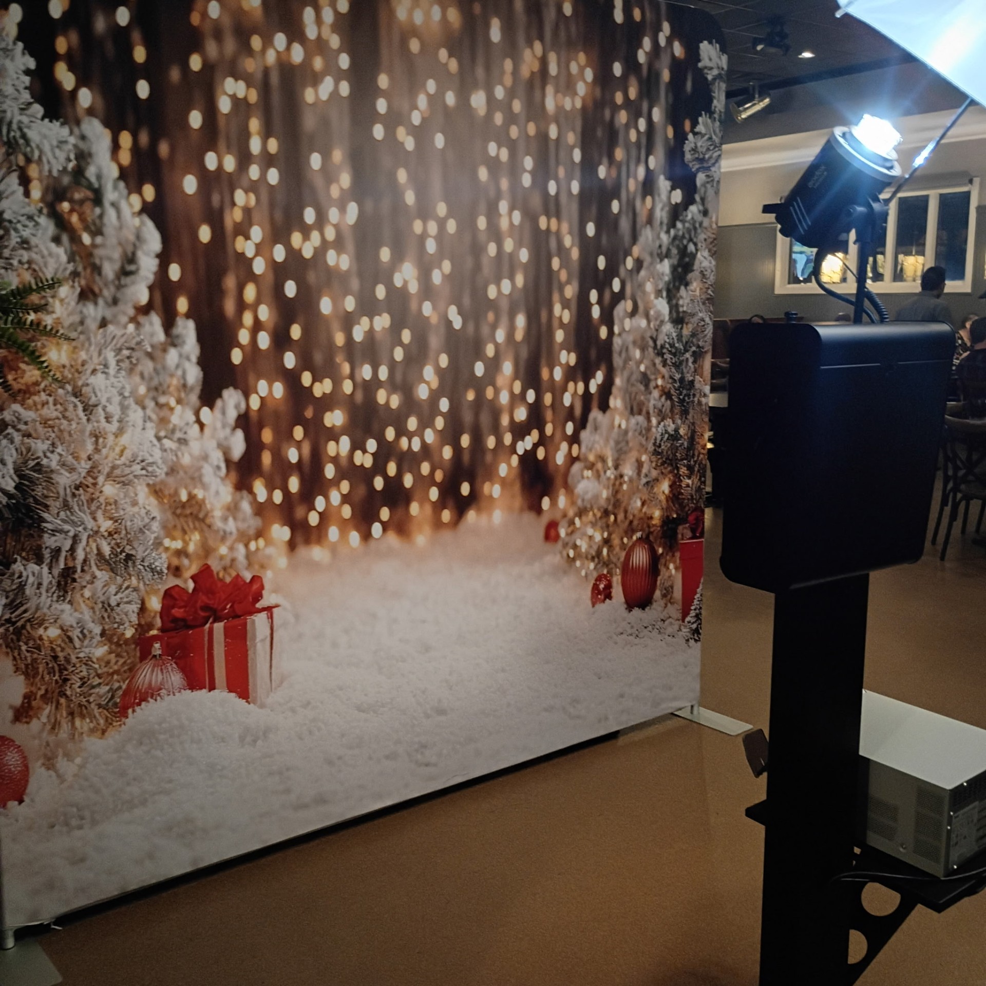 Holiday photo booth with festive backdrop